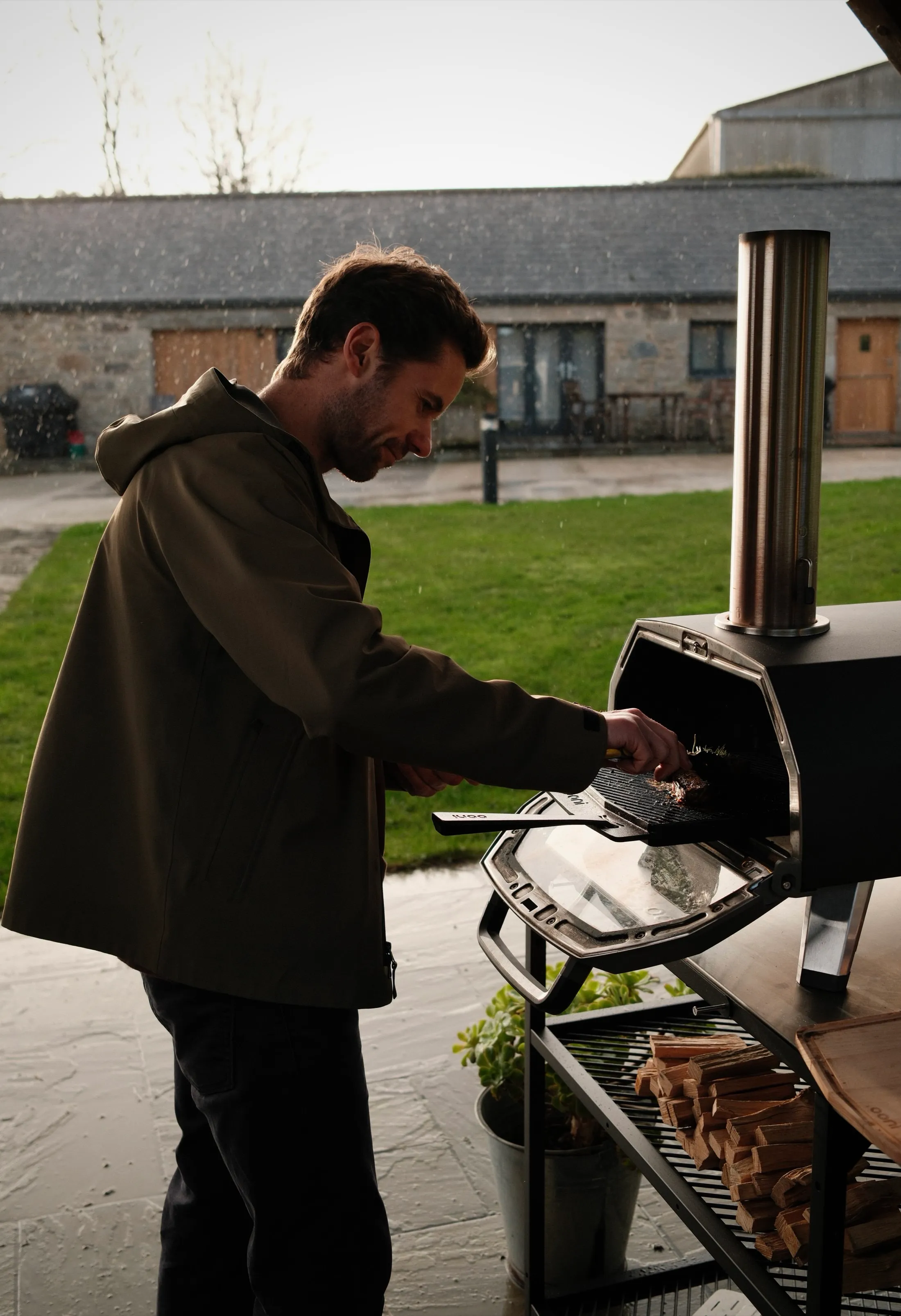 Grant cooking at his outdoor pizza oven